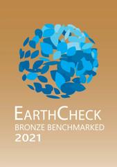 A graphic poster that says "EarthCheck Bronze Benchmarked 2021" in white on a brown gradient background with a circle made of blue leaf shapes above.