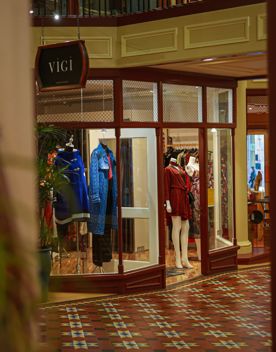 Vigi shop front inside the gold and red interior of Old Bank Arcade.