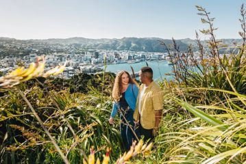 A young couple enjoy the view from Mount Victoria lookout in Wellington.