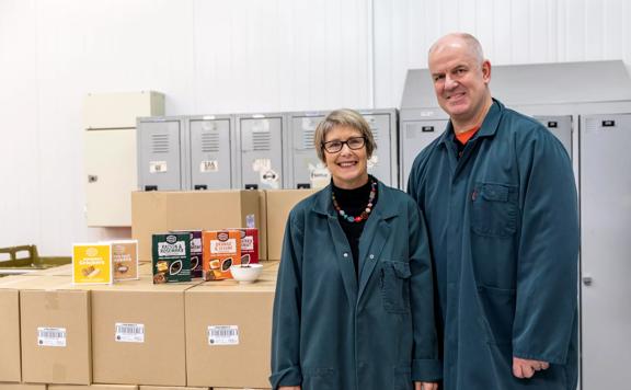 2 people standing next to their product, the Upcycled Grain Project.