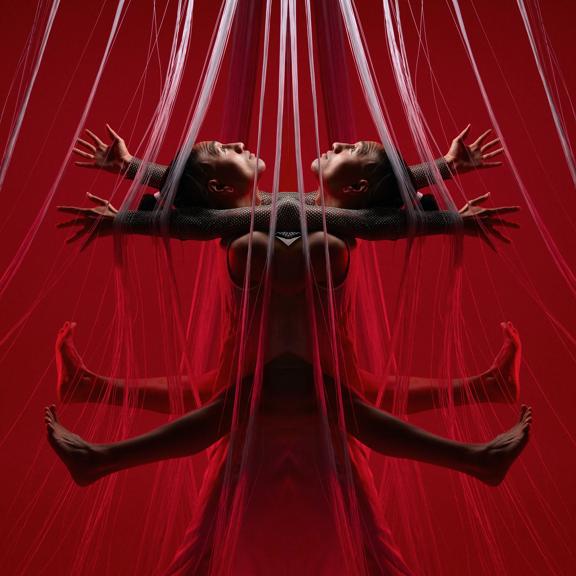 A symmetrical image of a dancer reaching their limbs outward with concentric strings suspended from above on a red background.