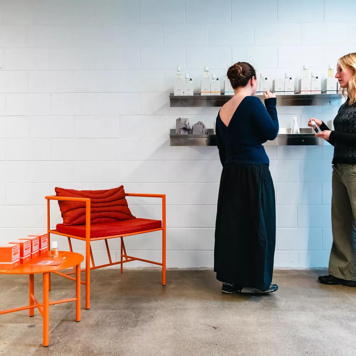 A wide of two people looking at a shelf of perfumes at Abel Odor Perfumery in Wellington.