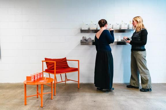 A wide of two people looking at a shelf of perfumes at Abel Odor Perfumery in Wellington.