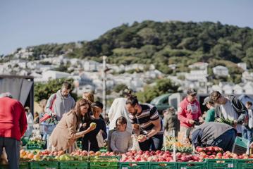 A family looking through the fruit baskets at the Harbourside Market.