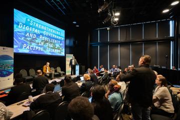 People attend a presentation at APNIC 58 at Tākina.