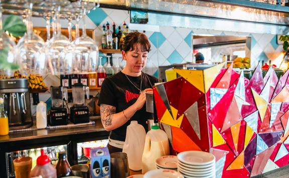 A waiter at Seashore Cabaret makes a coffee.