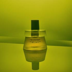 The Apartment fragrance bottle from Abel on a green background.