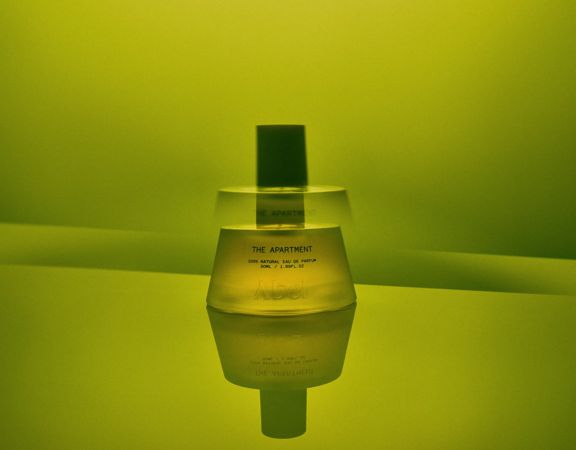 The Apartment fragrance bottle from Abel on a green background.