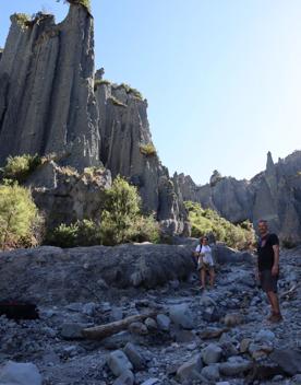Two people standing in a rocky canyon at the Putangirua Pinnacles track in the Wairarapa.