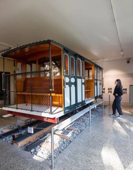A person looks at a life-size model of an old cable car at the Cable Car Museum in Kelbunr, Wellington.