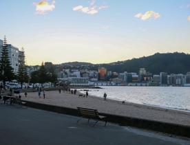 The screen location of Oriental Bay, wth pastel-coloured, Art Deco apartments, brightly-painted boat sheds, and the golden beach.