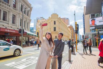 Two people take a selfie in front of the Old Bank Arcade.