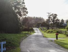 Mangaroa Valley Road screen location, a scenic rural setting with native forest, farmland, and a mountainous backdrop.