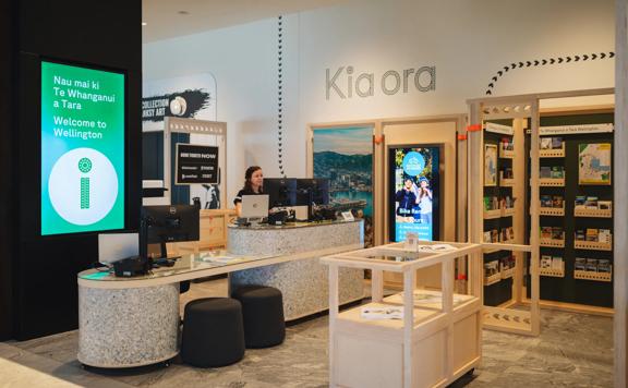 An employee stands at a computer in the Wellington isite at Tākina.