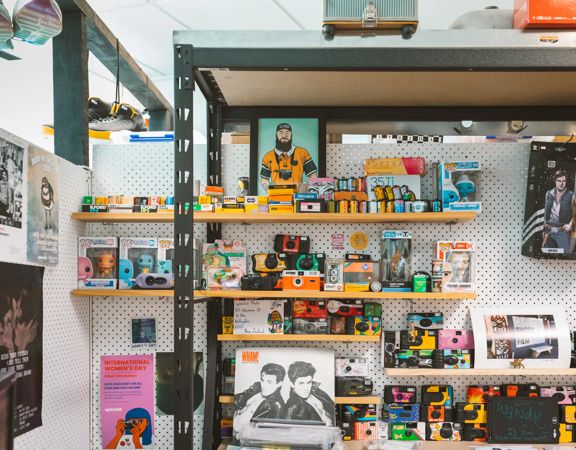 Shelves stocked with disposable cameras at Splendid Photo.