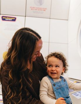 A mother and child play in the spaceship control room at Space Place in Wellington.