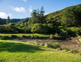 Camp Wainuiomata screen location. Has several buildings and is surrounded by forest and bush.