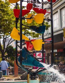 The Bucket Fountain with water splashing through the buckets. This is an iconic kinetic sculpture located in Cuba Mall in Wellington.