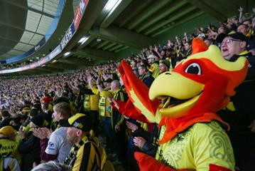 The Wellington Phoenix mascot is amongst a cheering crowd at Sky Stadium.