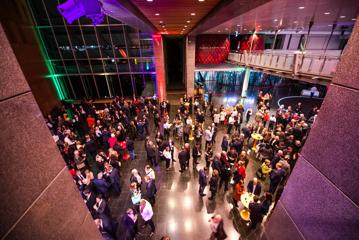 The foyer room at the Museum of New Zealand Te Papa Tongarewa during a event. The space is full of people in semi-formal wear.