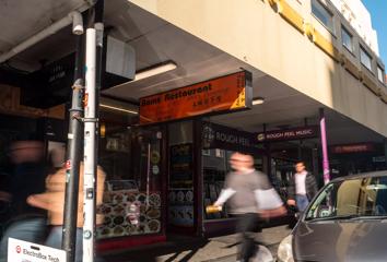 The entrance to Rams Restaurant on Cuba Street as people walk by.