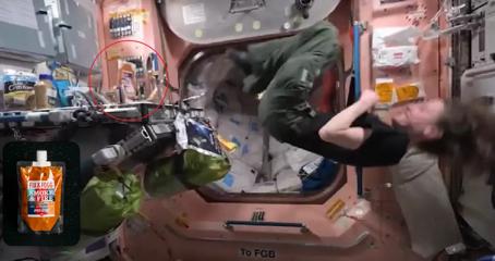 An astronaut aboard the International Space station doing a flip in the zero gravity, while the sachet of Fix & Fogg peanut butter sits in the corner.