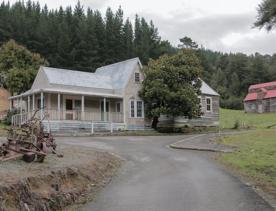 The screen location of Whiitemans Valley, nestled among trees and hills, old buildings have been built to mimic an old town.