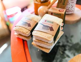 Several natural pot scourers sit in a pile on a glass table top.
