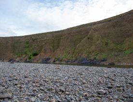 The screen location of Te Mārua  cliffs, where a river flows against vertical cliffs on the foothills of the Remutaka Range.