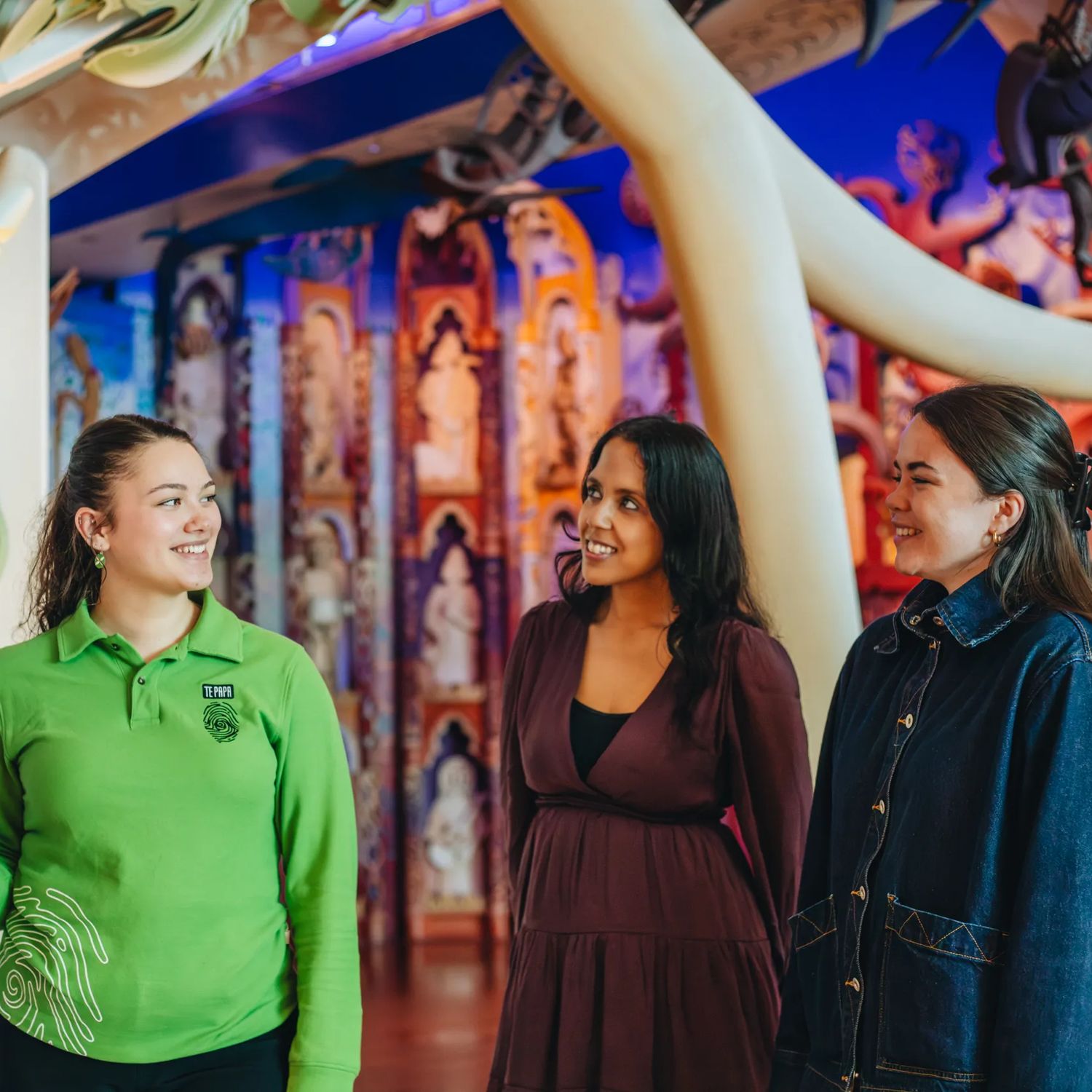 Two people at Museum of New Zealand Te Papa Tongarewa looking at an exhibition with a tour guide
