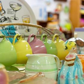 A collection of colourful vintage mugs and glasses.