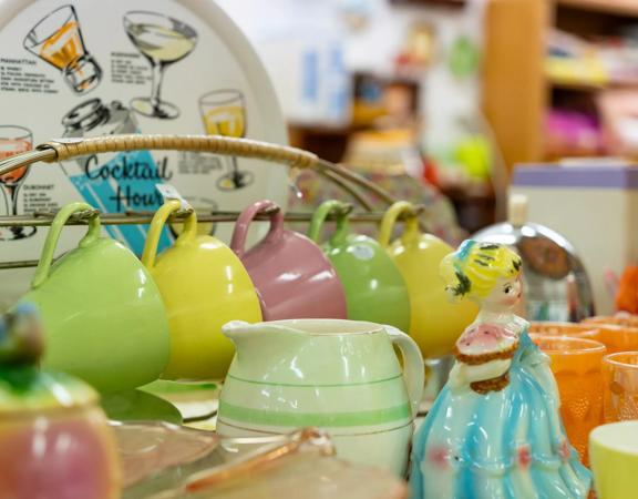 A collection of colourful vintage mugs and glasses.