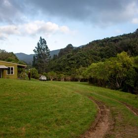 Camp Wainuiomata screen location. Has several buildings and is surrounded by forest and bush.