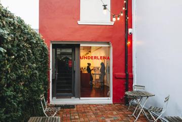 The front facade of Underlena, a lingerie store on Ghuznee Street in Te Aro Wellington. It's a narrow building painted bright red with double glass doors.