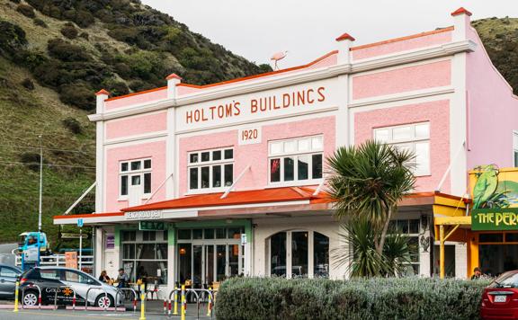 An exterior shot of the Holtoms art gallery in paekākāriki, a gorgeous old pink building with orange trim.