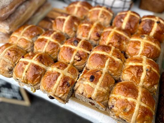 A tray of 18 hot cross buns fresh from the oven.