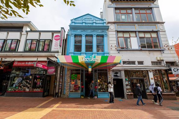 The beautiful blue exterior of Iko Iko contrasted to the grey of the buildings beside it on Cuba street.
