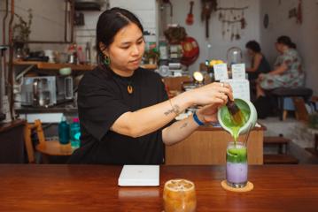 A barista prepares an iced pink matcha at Pour & Twist.