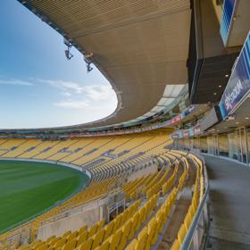 Looking out over the green field at sky stadium, over the yellow seats from the Sky Stadium function centre box.