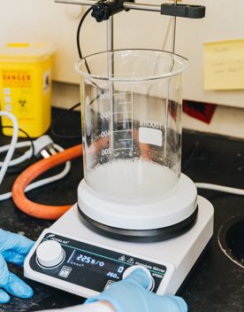 A beaker on a heating element in a laboratory.