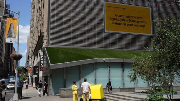 Giant ESC key in a New York City plaza with a billbord attached to the button.