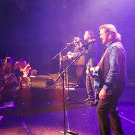 The Best of the Bee Gees tribute band performs on stage to a packed audience.