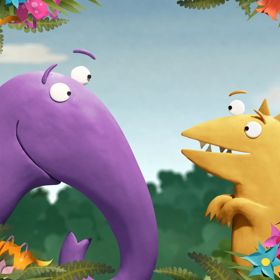The two main characters from the animated children's TV show Kiri and Lou look at each other behind a frame of flowers