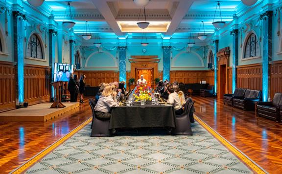 People enjoying a dinner meal inside parliament.