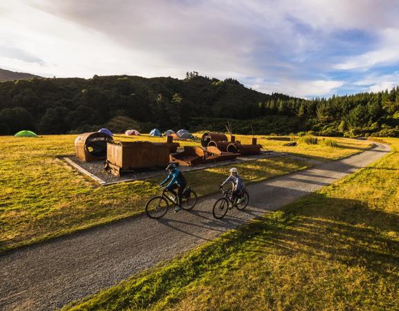 2 bikers at the summit of the Rail Trail Section on the Remutaka Cycle Trail.