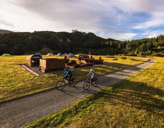 2 bikers at the summit of the Rail Trail Section on the Remutaka Cycle Trail.