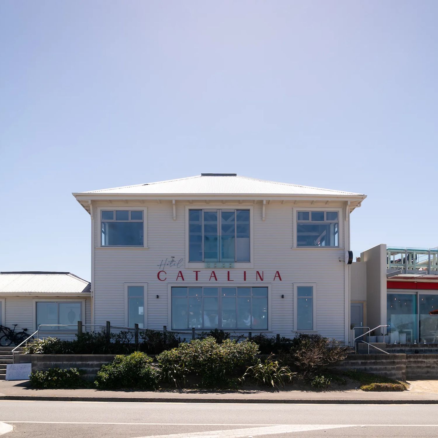 Exterior of Hotel Catalina, a large wooden building directly opposite Lyall Bay beach.