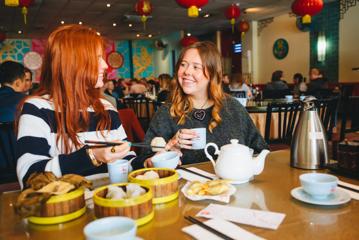 Two friends enjoy yum cha and tea at Dragon's Restaurant.