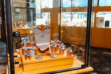 A display case at The Village Goldsmith holds several rings and other pieces of jewellery.