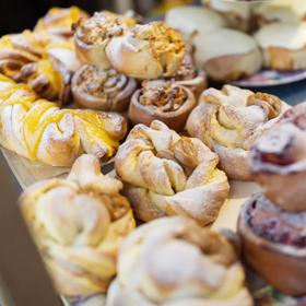 Stacks of baked twists and scrolls sit on decorative plates.